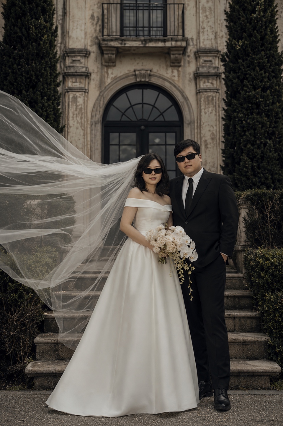Brian and Angie on the steps with veil